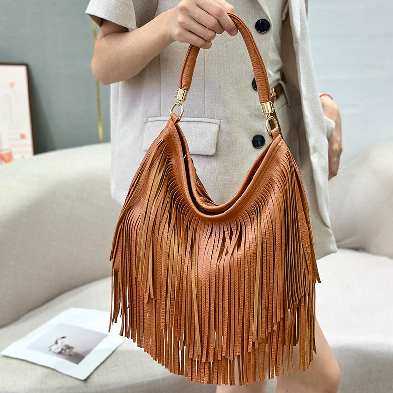 Sac bandoulière en cuir souple à double pompon